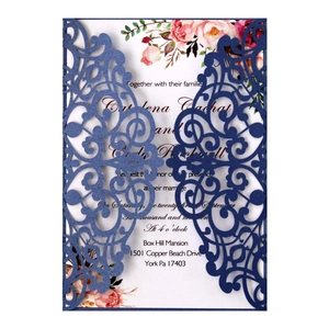 Laser cut navy blue wedding invitation with floral insert and elegant ribbon bow
