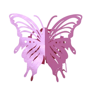 Detail of rose pink laser-cut hollow butterfly napkin ring with metallic finish surface