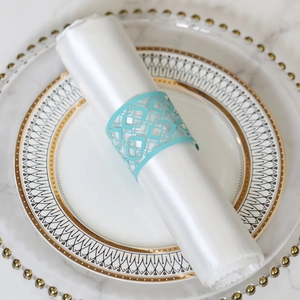 Close-up of laser-cut Tiffany blue napkin ring on a white satin napkin for wedding decor