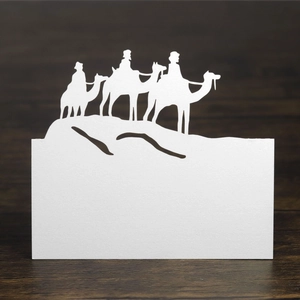 Laser-cut camel silhouette place card made of white paper for holiday table decor