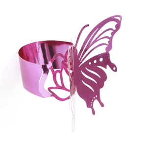 Macro shot of 3D laser-cut hollow butterfly napkin ring with reflective pink finish