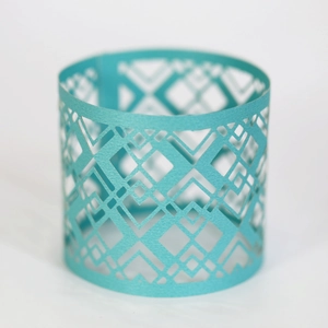 Detail showing the laser-cut geometric diamond patterns on mint green napkin rings