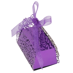 Detailed laser-cut rose pattern on purple hollow gift box with elegant ribbon bow