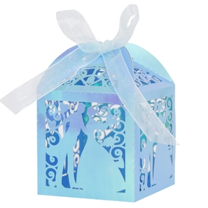 Detail of blue laser cut wedding favor box with romantic silhouette and ribbon bow