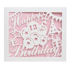 Detail of laser-cut Happy 13th Birthday card with pink insert and balloon motifs