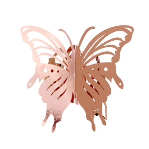 Close-up of 3D laser-cut butterfly napkin ring in rose gold finish for weddings
