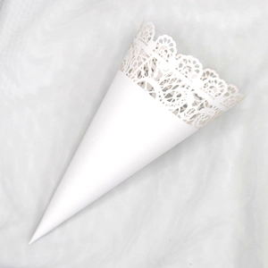 Close-up of white paper cone with delicate laser-cut lace edge for wedding confetti