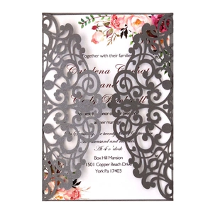 Laser cut wedding invitation with grey swirl pattern and floral printed inner card