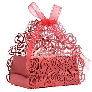 Detail of red laser-cut hollow rose pattern on gift box with organza ribbon bow