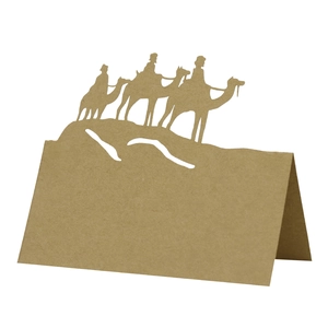 Detail of laser-cut camel silhouette kraft paper place card for holiday party table decor