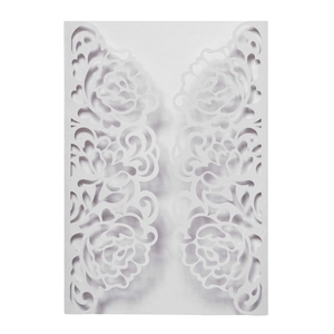 Detail showing intricate laser-cut rose patterns on elegant white wedding invitation cover