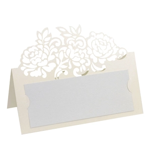 Detail of laser-cut pink rose hollow design on pearlescent paper wedding place card