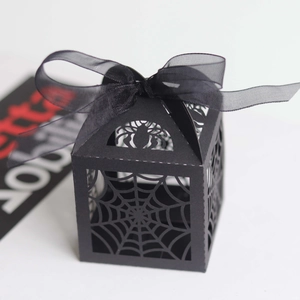 Black laser-cut spider web Halloween candy box with ribbon and spider top detail