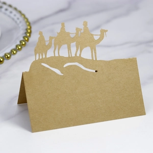 Detail of laser-cut kraft paper place card featuring a hollowed camel silhouette design