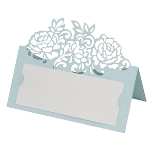 Macro detail of laser-cut rose hollow design on light blue pearlescent place card