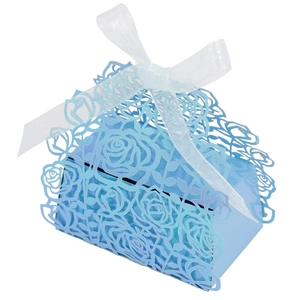Detail of light blue laser-cut rose hollow candy box with elegant white ribbon bow