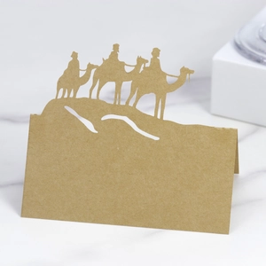 Detail showing laser-cut camel silhouette on a folded kraft paper place card
