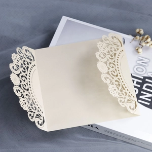 Beige laser-cut hollow invitation card with intricate floral patterns for weddings and parties