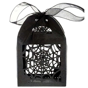 Detail of laser-cut black spider web candy box with elegant organza ribbon for Halloween