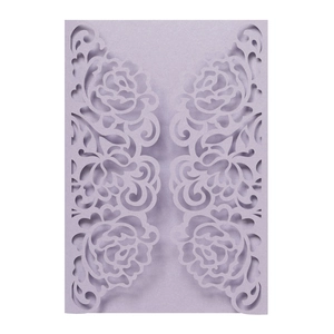 Close-up of laser-cut rose patterns on lavender pearlescent paper invitation cover