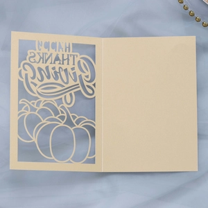 Detail of laser-cut Happy Thanksgiving card with pumpkin motifs and elegant cream paper