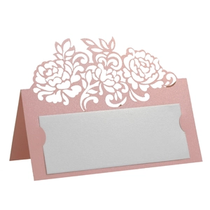 Macro detail of laser-cut pearlized pink rose place card with white insert for weddings