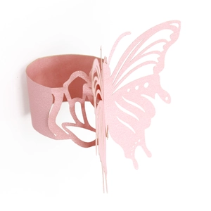 Close-up of laser-cut 3D butterfly napkin ring in pearlescent pink for wedding decor