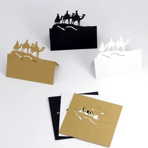 Laser-cut camel silhouette place cards in black, white, and kraft paper for party decor