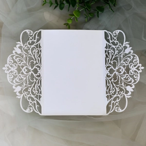 Elegant white laser-cut floral wedding invitation card with intricate vine patterns