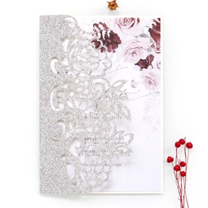 Silver glitter laser cut floral wedding invitation with pink rose insert card on white background