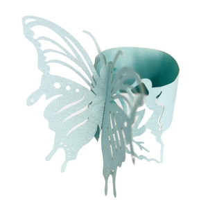 Macro view of light blue laser-cut butterfly napkin ring with detailed 3D hollow wings