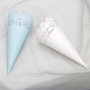 Detail of light blue and white lace paper cones for wedding confetti with hollow design