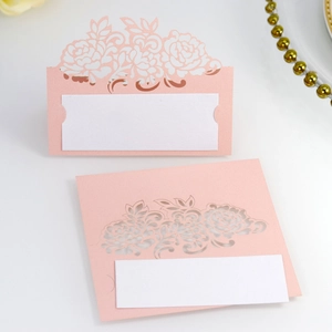 Detailed laser-cut pink rose table cards with white insert for wedding place settings