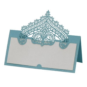 Detailed laser-cut lace place card in pearlescent blue and white for wedding tables