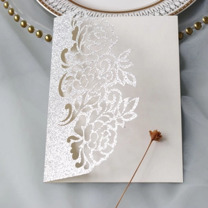 Silver glitter laser-cut rose wedding invitation on grey tulle with decorative plate