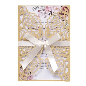 Detailed laser-cut floral invitation cover with rose print card and cream satin bow