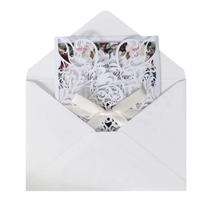 Elegant laser-cut wedding invitation set with floral inner card and cream satin bow