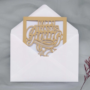 Detail of laser-cut golden Happy Thanksgiving card in a white V-flap envelope