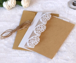 Detail of laser-cut lace card with kraft paper envelope and natural twine tie