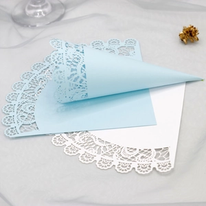 Laser cut lace paper cones in light blue and white for wedding party petals and confetti