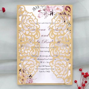 Macro detail of laser-cut gold rose pattern on lavender wedding invitation card