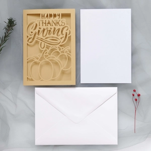 Laser-cut Happy Thanksgiving card set with pumpkin design and white envelope