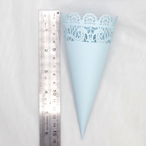 Detail of light blue laser-cut lace paper cone for weddings with ruler showing 15cm length