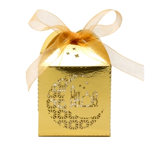 Macro shot of gold hollow gift box featuring laser-cut moon and mosque patterns