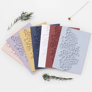 Detailed laser cut rose patterns on multi-color pearlescent wedding invitation cards