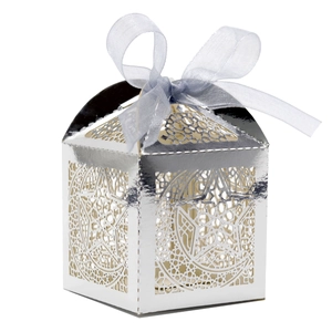 Silver laser-cut candy box with hollow star and moon patterns and a blue ribbon bow