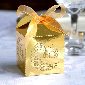 Detailed hollow-out moon and star design on a mirror gold Ramadan candy box with ribbon