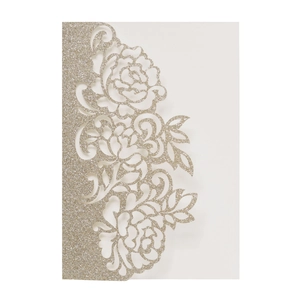 Detail of laser-cut glitter paper rose pattern on champagne gold wedding invitation