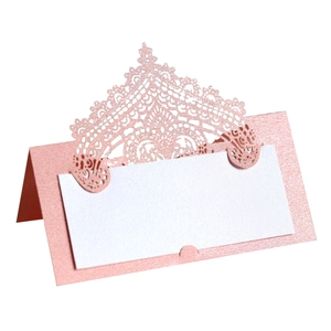 Elegant laser-cut lace place cards in pearlescent pink for wedding table seating