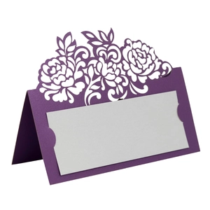 Macro view of purple laser-cut rose place card with white insert for wedding tables